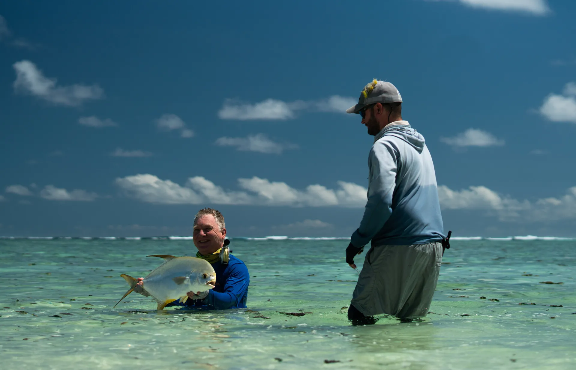 Guide and angler with an Indo-Pacific permit caught wading the flats